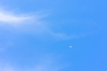 Blue sky with tiny cloud and moon background.Blue sky with tiny cloud and moon background.