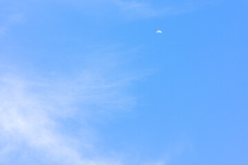 Blue sky with tiny cloud and moon background.