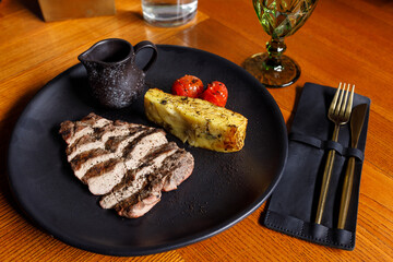 Pork tenderloin with pepper sauce and potato gratin