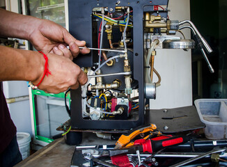 A man fixing coffee machine,repairing broken coffee machin.