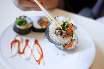  tuna Sushi on plate with chopstick on table 