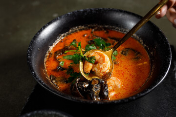 Tom Yam with salmon, shrimps and tree mushrooms