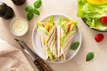 Wrap burrito sandwich or kebab with flatbread with vegetables and white meat. Delicious healthy food, take away snack