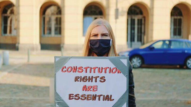 Protest Walk: Woman In Protective Mask Advocating For Constitutional Rights Protection. She Holding Banner And Going On The Street.