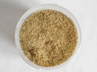 Dry sphagnum, peat moss, perennial marsh white moss of light brown beige yellow color in a transparent large bucket, top view, close-up