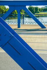 The oldest steel, arc, rivered, painted blue, bridge over the Vistula River in Krakow, Poland. Jozef Pilsudski bridge called 