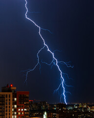 Single spectacular large lightning over the night city