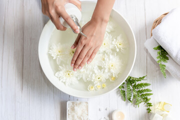 Spa treatment and massage product for female manicure nails skin care with white flower.  Woman happy and relax with spa massage Thai. Healthy and Beauty  Concept.