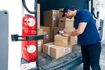 Smiling courier checking packages using portable information device © gpointstudio