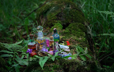 Magic witch bottles and mineral gemstones, natural forest background. Magic, Witchcraft, spiritual...
