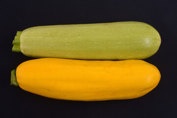 Courgettes blanches Lorea et courgettes jaunes crues sur fond noir