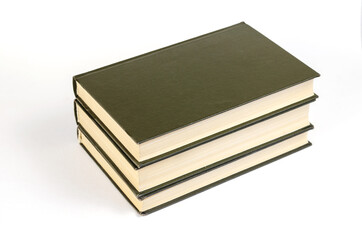 Three Green hardcover books on a white background. Stack of closed books.