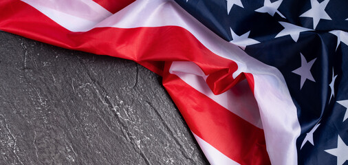 Concept of Independence day or Memorial day. Flag over dark slate table background.