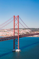 View from Almada of suspension  Ponte 25 de Abril bridge (The 25th April Bridge) over river Tejo in Lisbon, Portugal. Bridge alike Golden gate in Portugal. 
