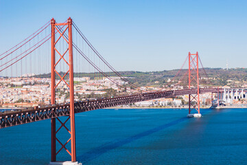 View from Almada of suspension  Ponte 25 de Abril bridge (The 25th April Bridge) over river Tejo in Lisbon, Portugal. Bridge alike Golden gate in Portugal. 