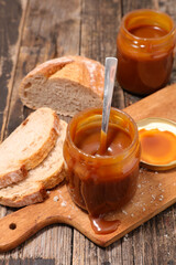 salted caramel sauce and bread on wooden board
