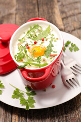 baked egg with cream and arugula