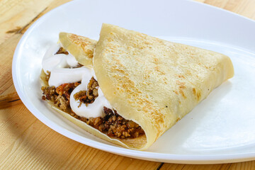Pancake with minced meat and sauce