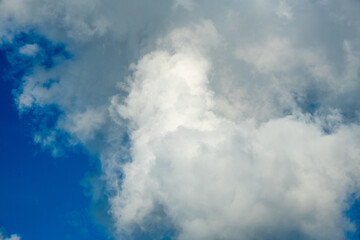 Fluffy white clouds and a blue background
