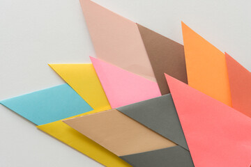 triangle-shaped folded construction paper backgrounds - bursts of pointy shapes in yellow blue sand pink brown orange and watermelon pink