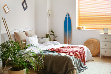 Interior of modern bedroom with surfboard