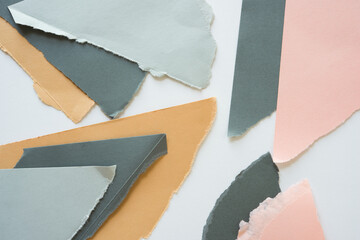 ripped paper background in brown light and dark grey pink and sand layered on white