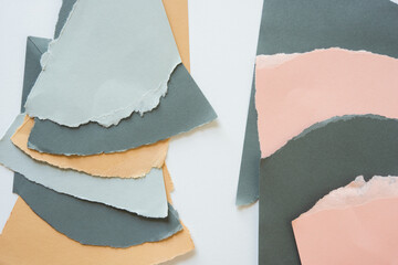 ripped paper background in brown light and dark grey pink and sand layered on white