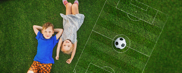children lying on the green grass in the Park. The interaction of the children