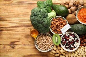 Healthy products rich in vitamin E on wooden background