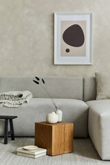 Creative composition of stylish modern spacious living room with mock up poster frame, grey sofa, wooden cubes, pillows, plaid, carpet, white design vases and small personal accesories. Template.