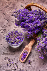 Fototapeta na wymiar Lavender flowers in basket on gray concrete background. Top view.