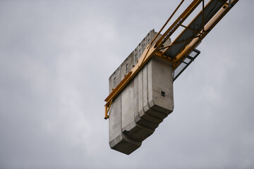 Concrete weight blocks of a construction crane. Heavy cement blocks are used as counterweights to balance a tower. Crane weights close up.