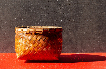 Tompo is a tool for cooking rice traditionally made from bamboo soil. on a black background on a red table.