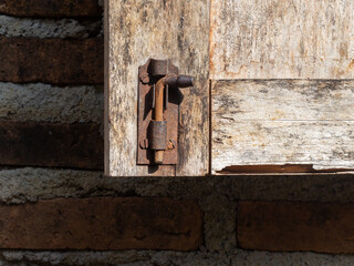 brown wooden door opens with latch lock. very classic and attractive.