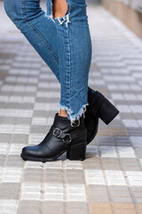 woman legs wearing brown black leather fashion shoes with casual clothes with very stylish bottom