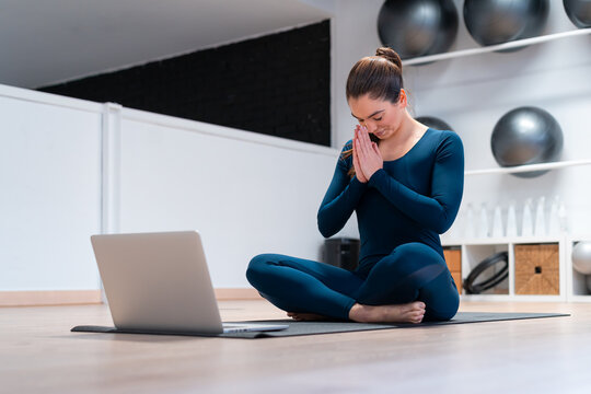 Yoga instructor using laptop during online class