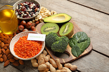 Healthy products rich in vitamin E on wooden background, closeup