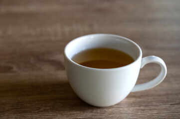 Vintage white tea cup on wood table,soft focus.