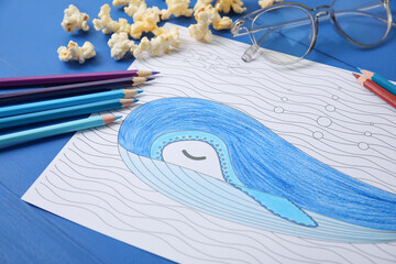 Coloring picture, glasses and pencils on wooden background, closeup