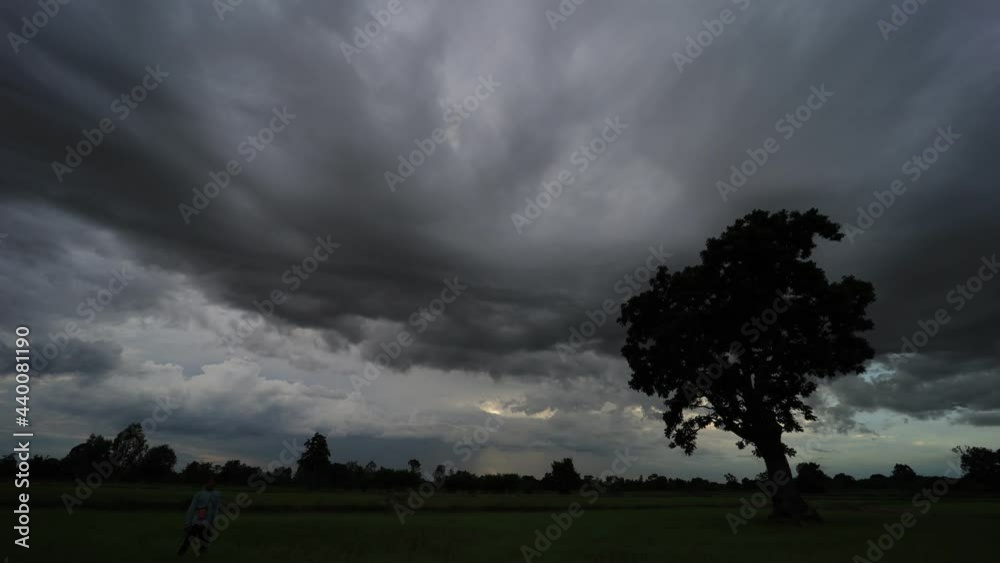 Wall mural the sky and rain clouds move quickly over the fields in the evening.