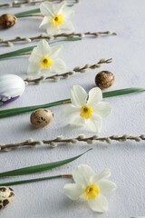 Obraz na płótnie Canvas Beautiful Easter composition with narcissus flowers, willow and eggs on light background