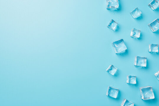 Above photo of transparent cubes ice isolated on the blue background with copyspace - Powered by Adobe
