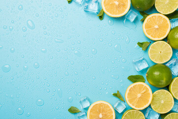 Top view photo of mint leaves whole and sliced limes halves of lemon ice cubes on the right and...