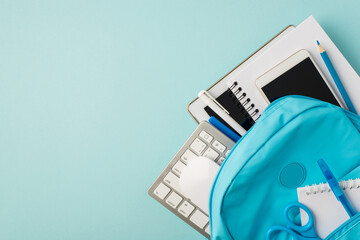 Top view photo of bag with tablet computer smartphone notepads pencil pens keyboard mouse and scissors on isolated pastel blue background with copyspace