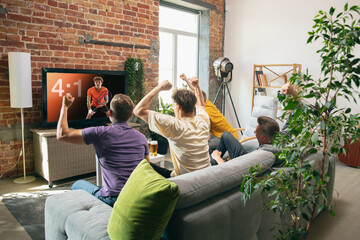 Group of friends watching TV, sport match together. Concept of friendship, leisure activity, emotions