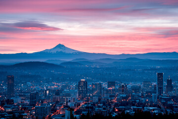 A colorful, pink sunrise with Mt. Hood and Portland, Oregon featuring a lenticular cloud over Mt Hood