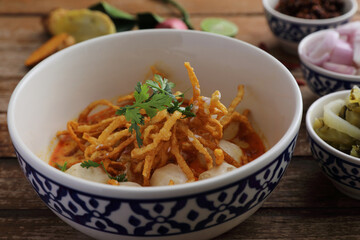 Local northern Thai food Egg noodle curry with meatballs on wood background
