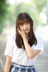 beautiful asian japanese school girl uniform looking at park outdoor