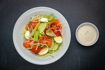 Delicious salads on a dark table
