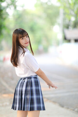 beautiful asian japanese school girl uniform looking at park outdoor